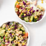 two white plates of brown rice salad