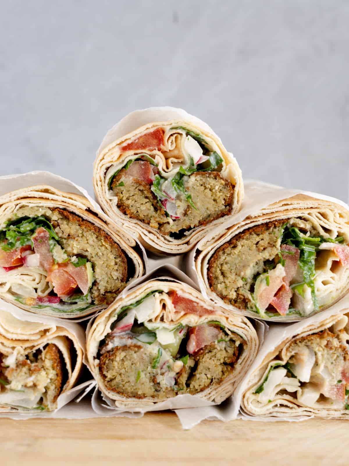 a stack of veggie and falafel sandwich rolls