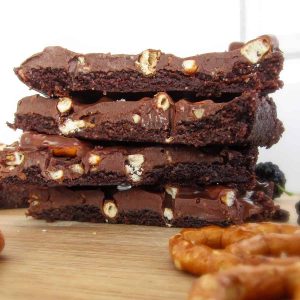 a stack of four chocolate slices with pretzels