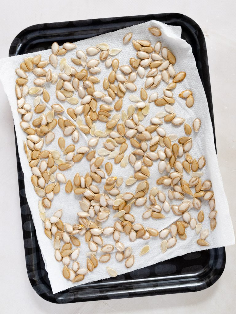 drying pumpkin seeds on a paper towel
