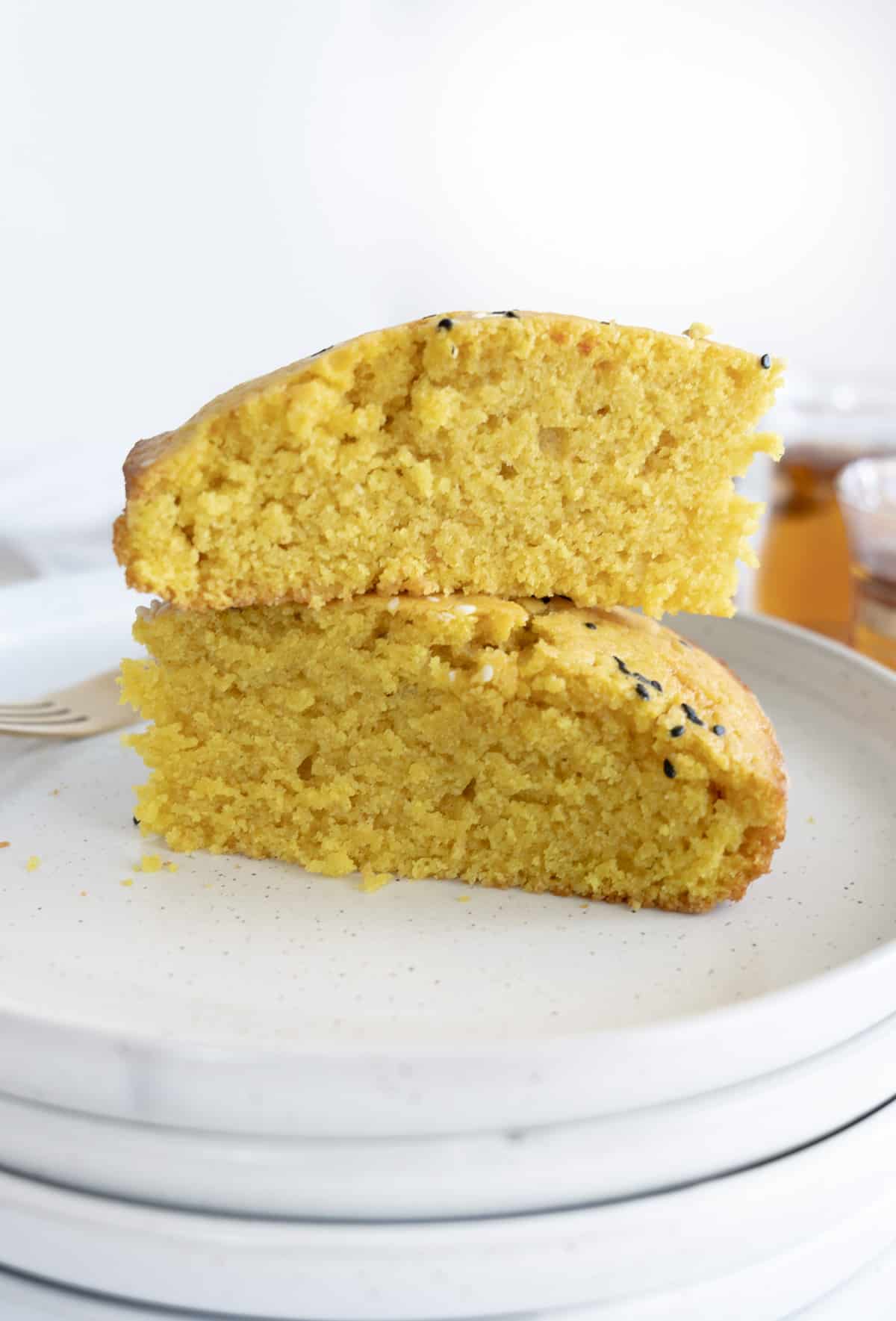 two slices of yellow semolina cake stacked on top of each other