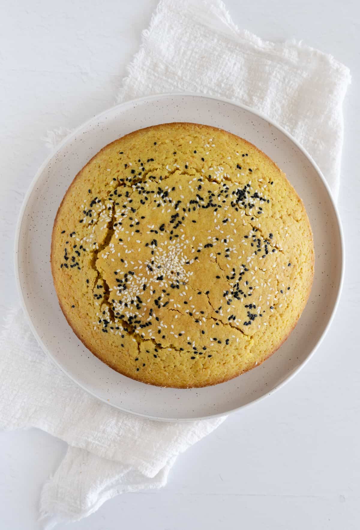 a round yellow cake in a white plate