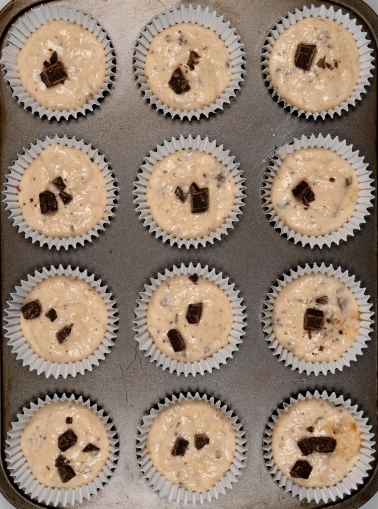 12 non baked choc chip muffins in a muffin tray