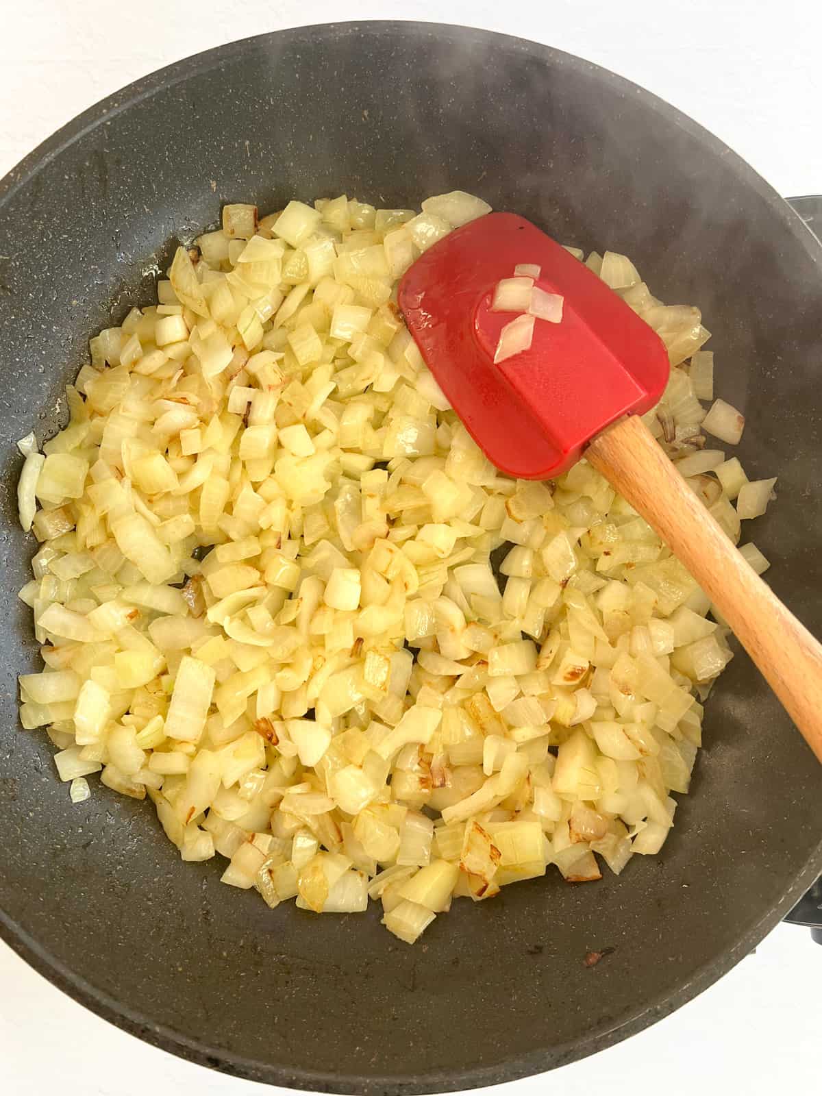 frying chopped onions in a fry pan