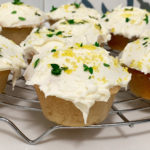 Lemon and thyme cupcakes sitting on a wire rack