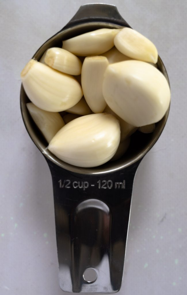 peeled garlic in a half cup measurement