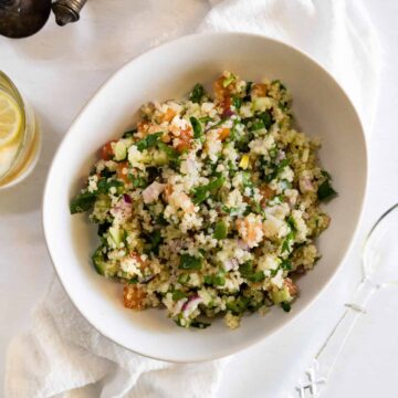 a white bowl with quinoa salad in it