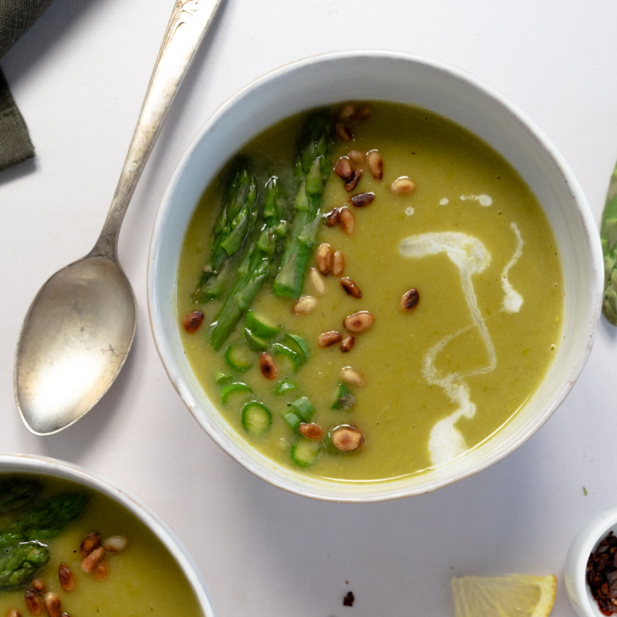 a white bowl of asparagus soup