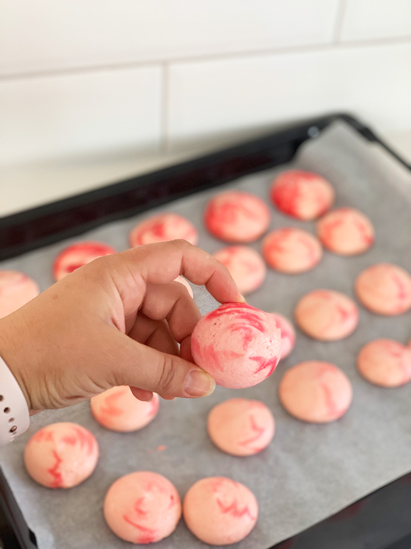 pink cookie held by a hand