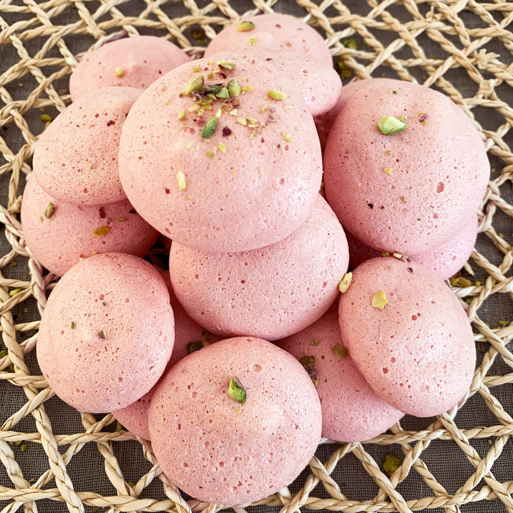 Vegan Meringue that are pink and garnished with pistachio