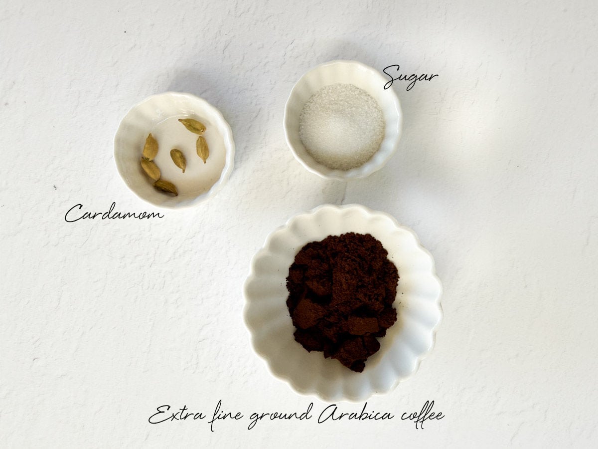 ground Lebanese coffee, sugar and cardamom pods in bowls
