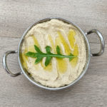 Lebanese Baba Ghanouj dip with Mint served in a steel bowl and garnished with olive oil and rocket
