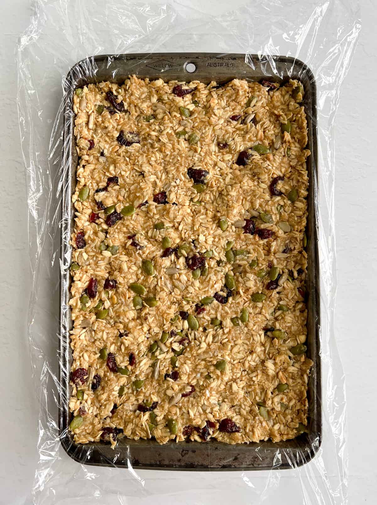 granola mixture pressed flat into a tray