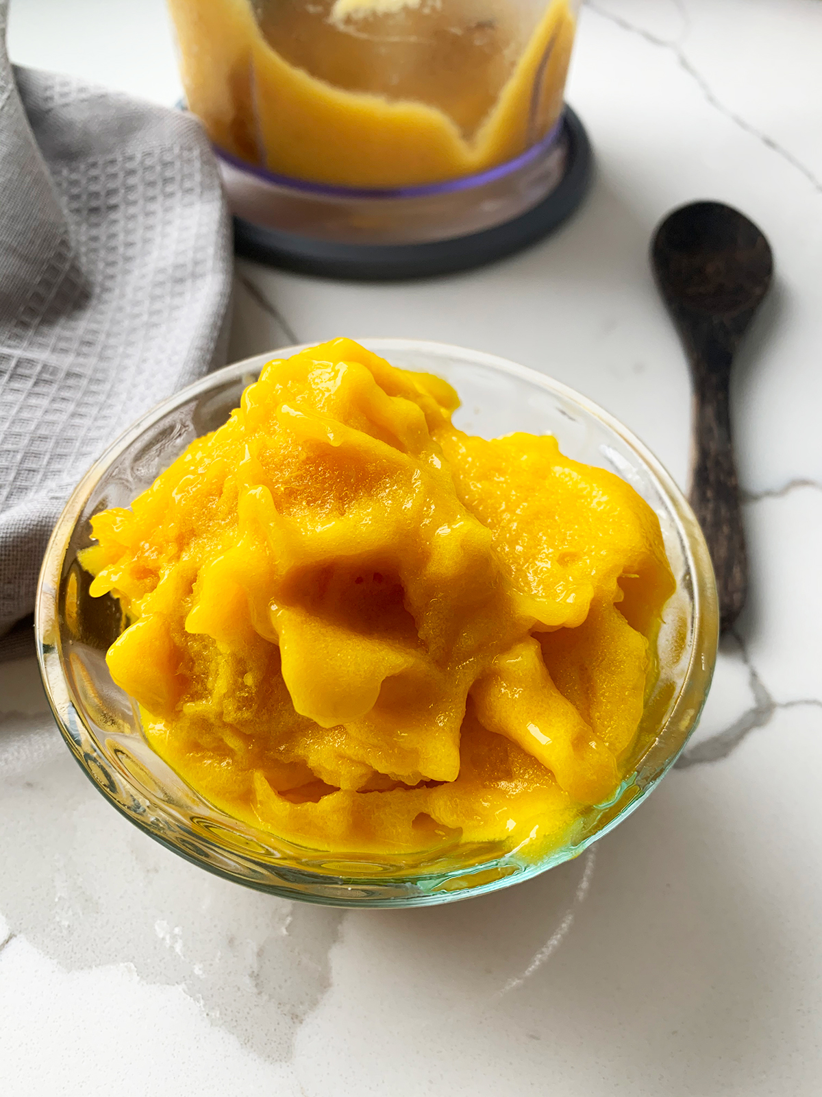 All natural mango sorbert served in a glass bowl