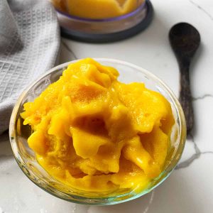 a glass bowl of creamed frozen mango