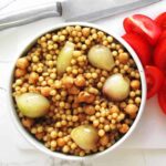 pearl couscous with pearl onions and chickpeas in a bowl