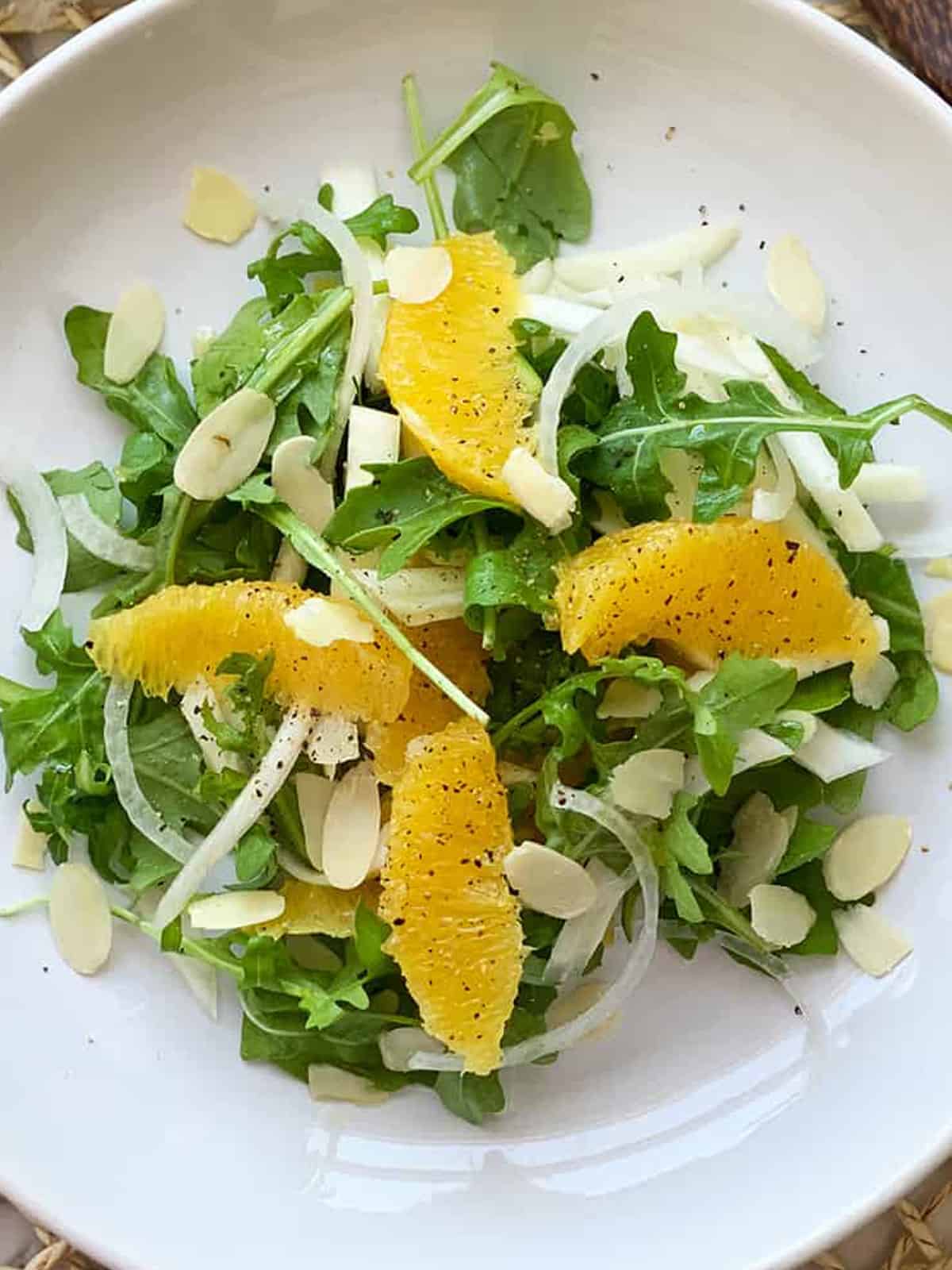 salad of green leaves, orange segments, almonds, sliced fennel and onion