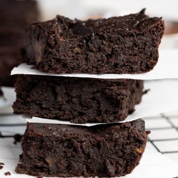a stack of three brownies with baking paper in between each one
