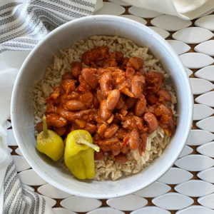 Lebanese Red Kidney Bean Stew Fasolia served with brown rice in a white bowl