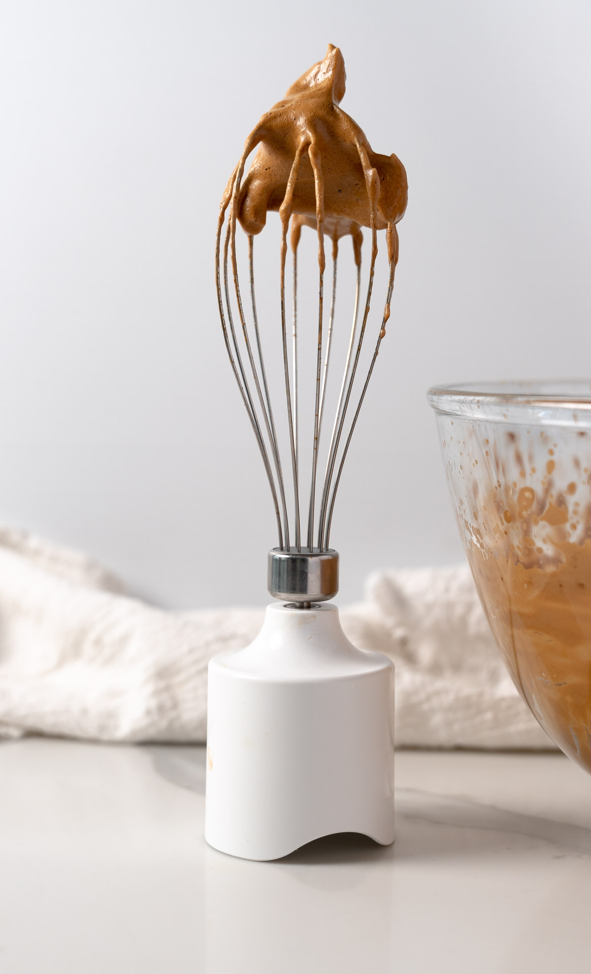 a whisk with foamed coffee