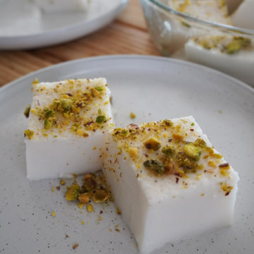 Haytaliyeh with crushed pistachio on top and tray in the background