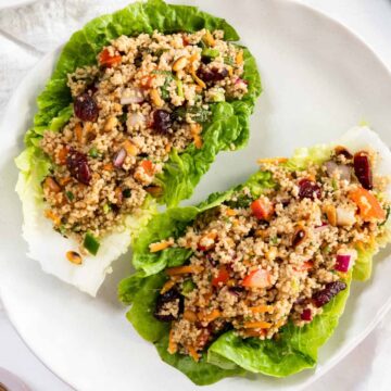 two lettuce cups filled with couscous salad