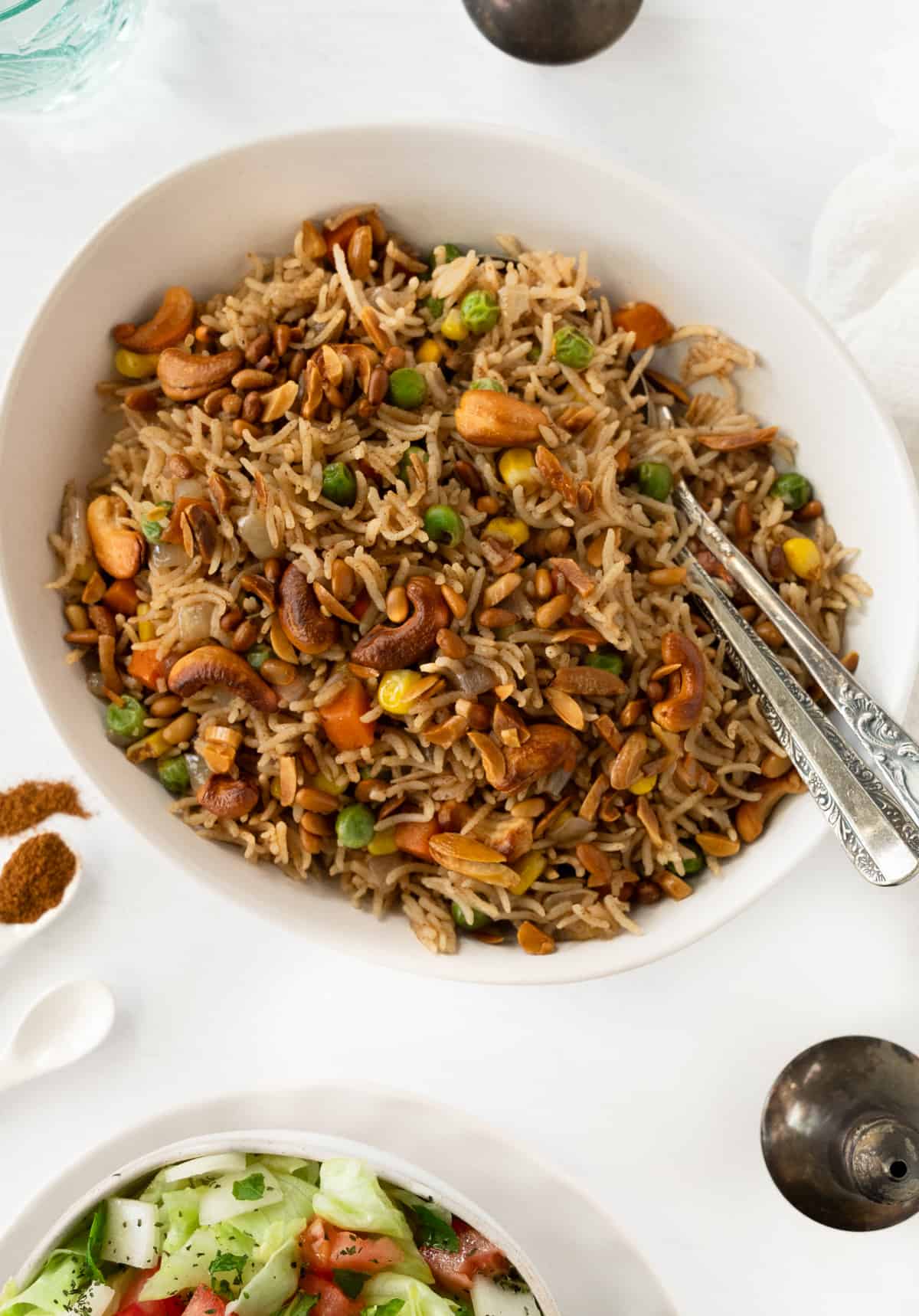 a bowl of spiced cooked rice with veggies and toasted nuts