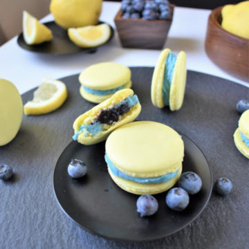 lemon blueberry macarons on black plate