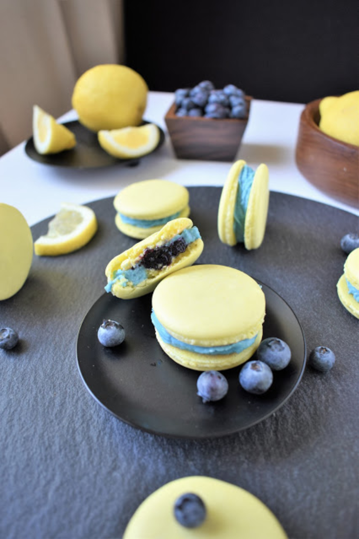 lemon blueberry macarons on black plate