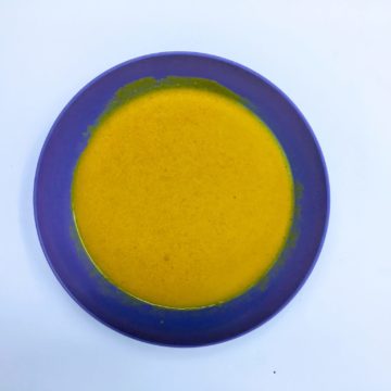 mustard dressing in a blue bowl birds eye view