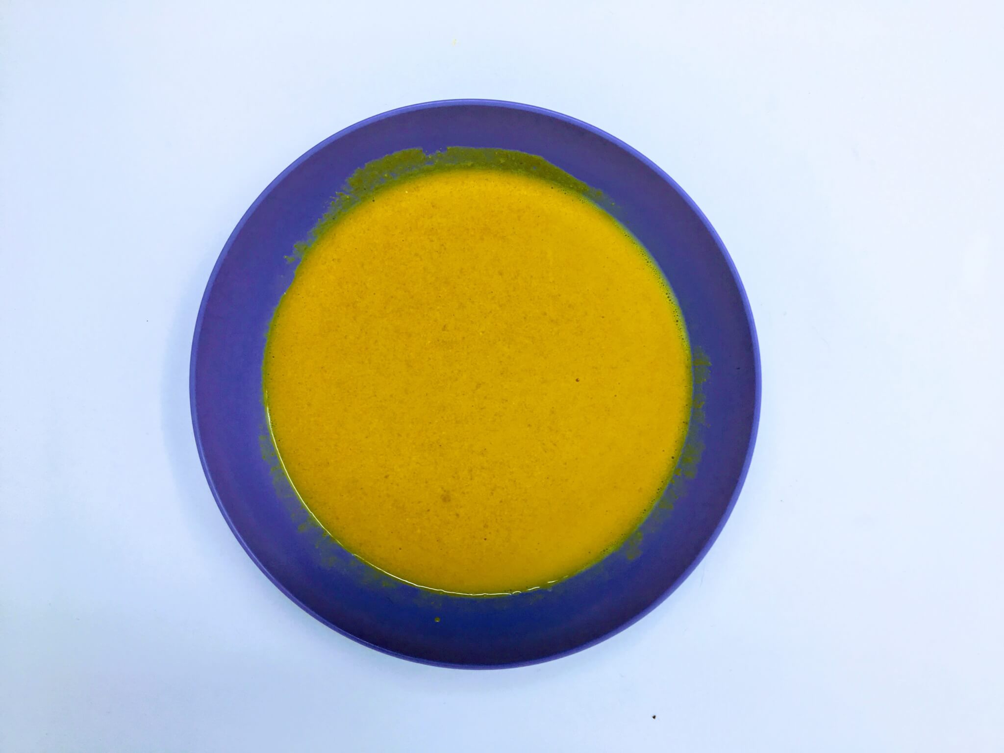 mustard dressing in a blue bowl birds eye view