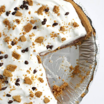 smores pie in a pie tray with a slice missing