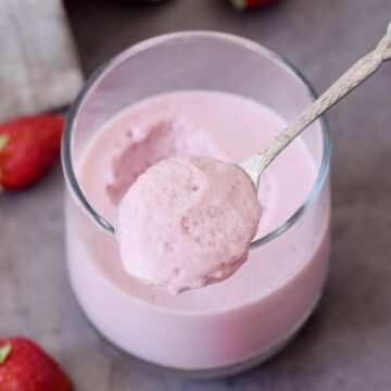 Strawberry mousse spooned out of a cup