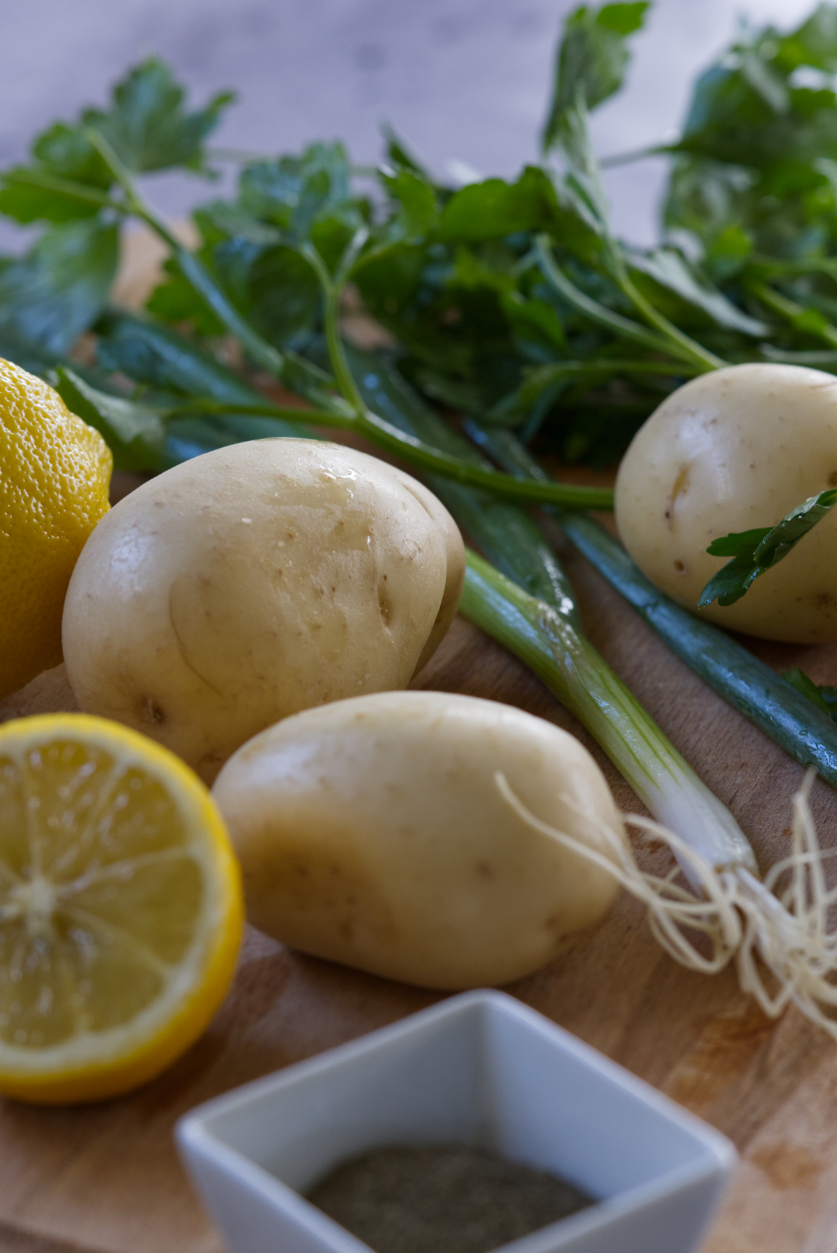 Lebanese potato (salata batata) ingredients including lemon, dried mint, parsley, potato and shallots