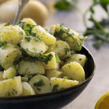 Lebanese Potato Salad (salata batata) in a dark blue bowl