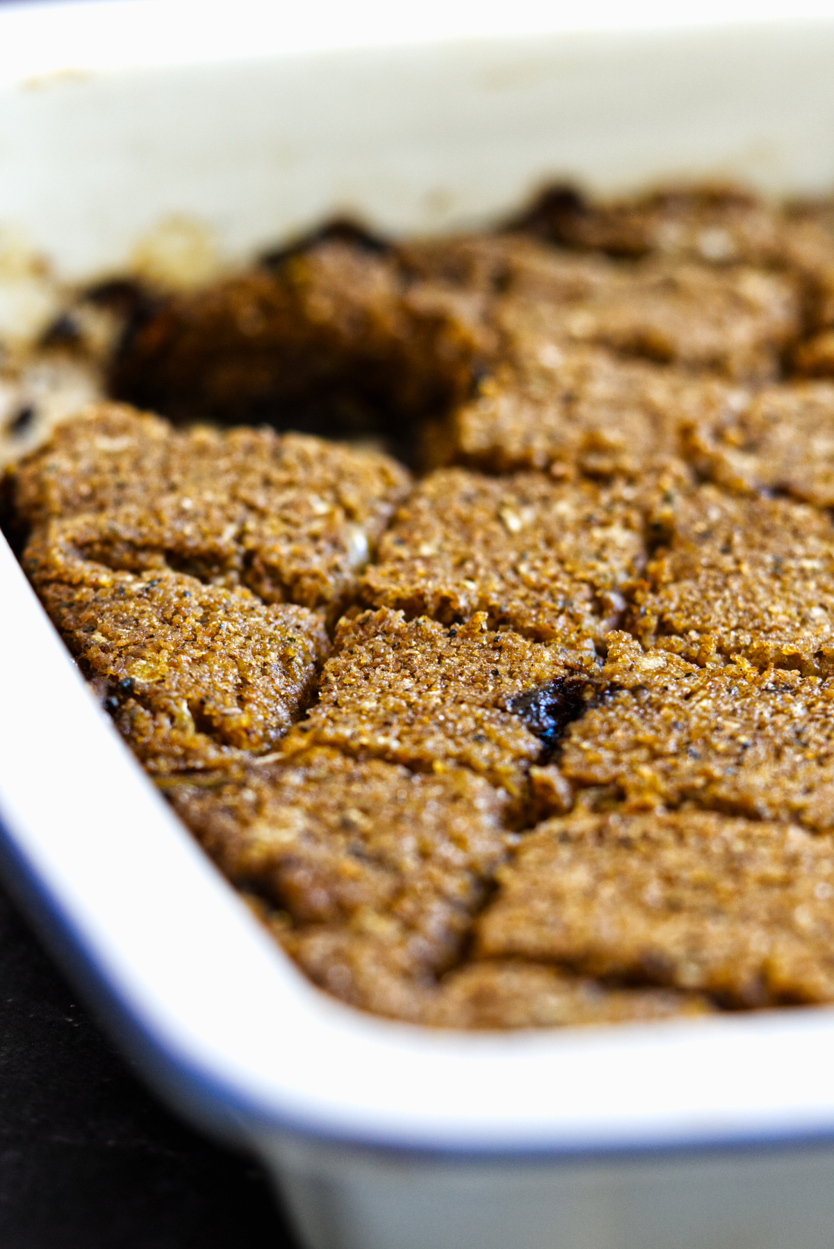 a close up of lebanese kibbeh in a white tray