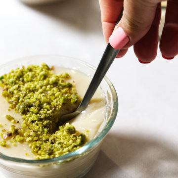 Lebanese Rice Pudding Riz Bi Haleeb in a bowl with pistachio