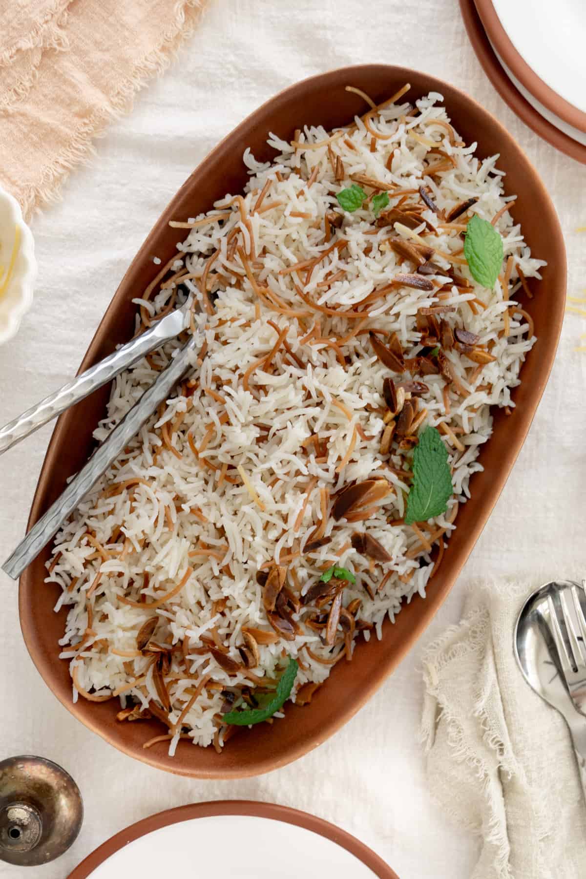 lebanese vermicelli rice in a brown bowl with silver cutlery