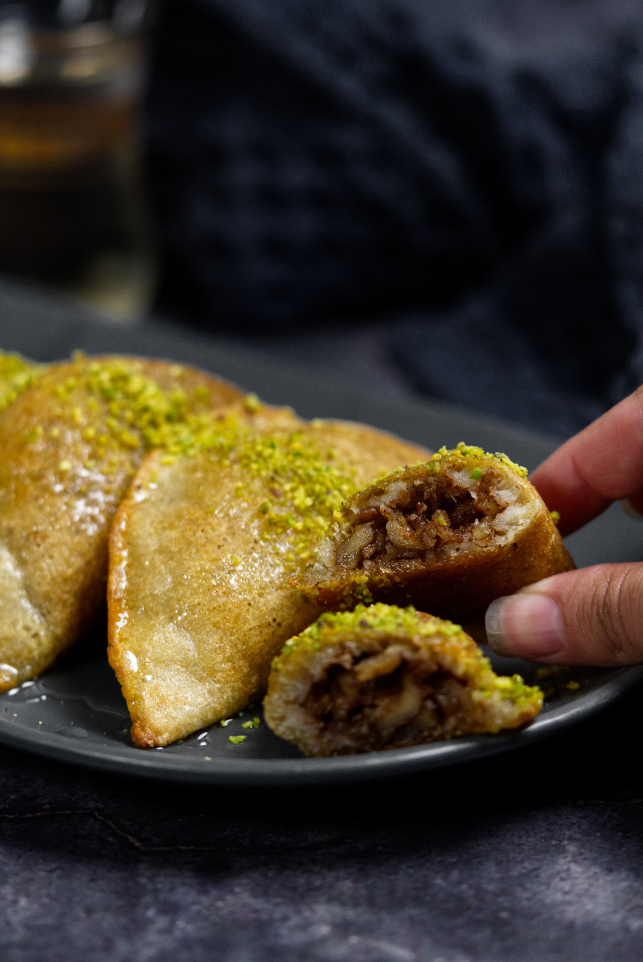 atayef cut in half to show walnut stuffing