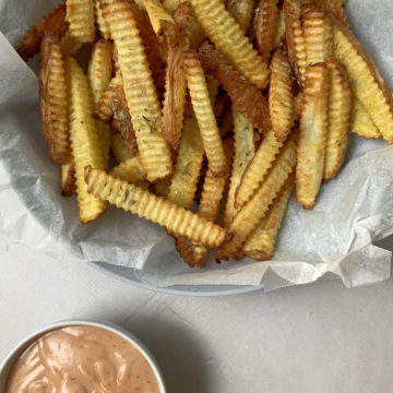 air fried french fries in a bowl with a side of fry sauce