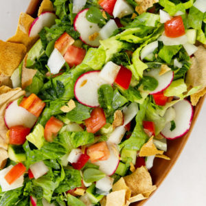 a close up of fattoush in a brown plate