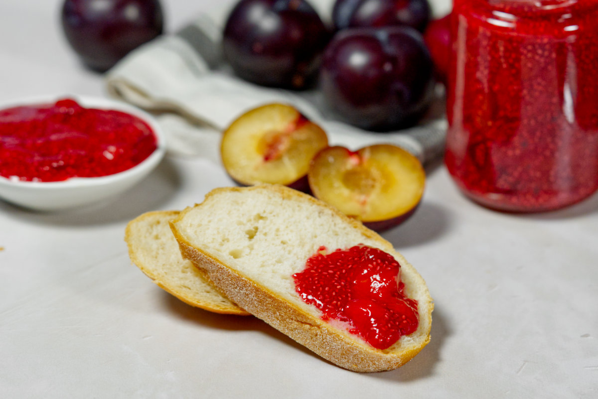 plum jam on bread with blums in back ground