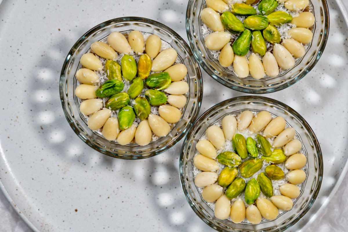 three bowls of meghli topped with nuts