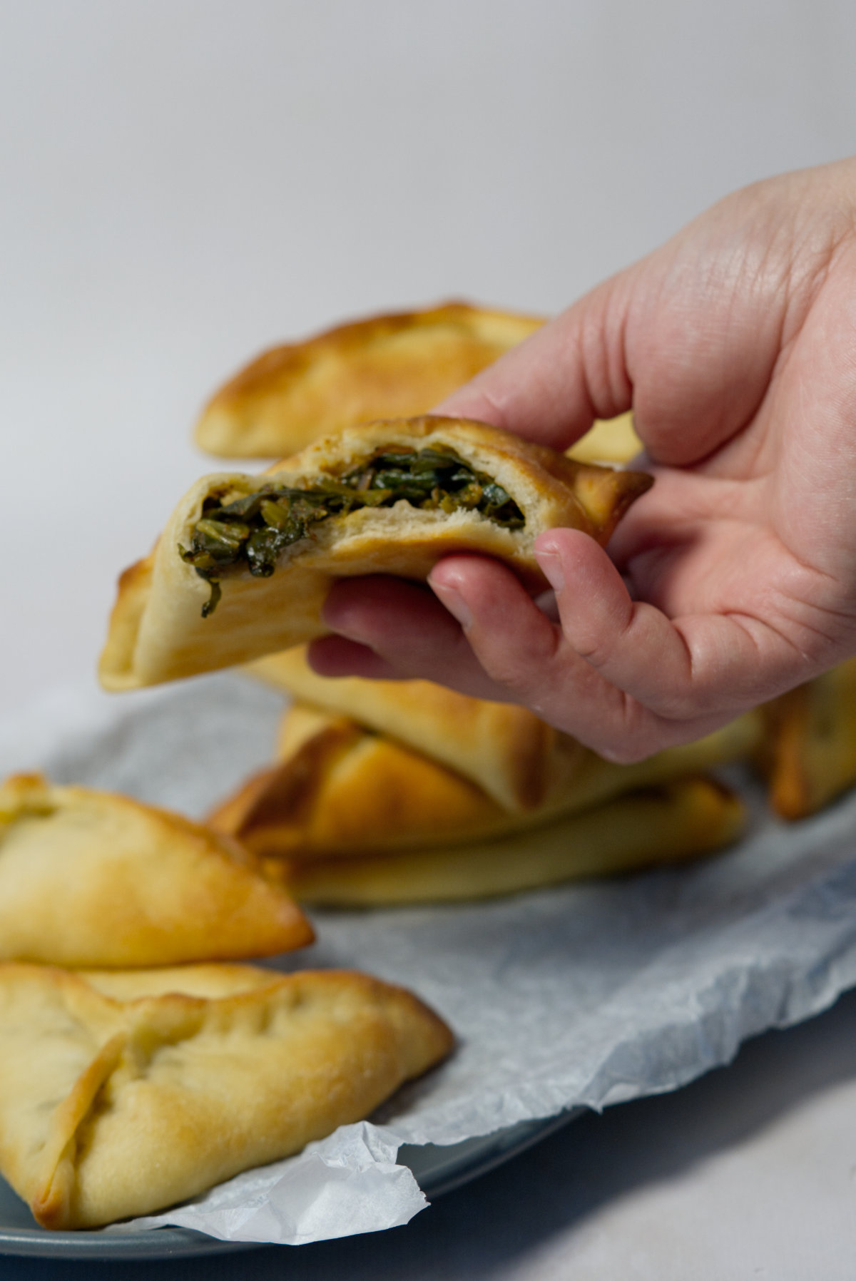 lebanese spinach pie held in a hand