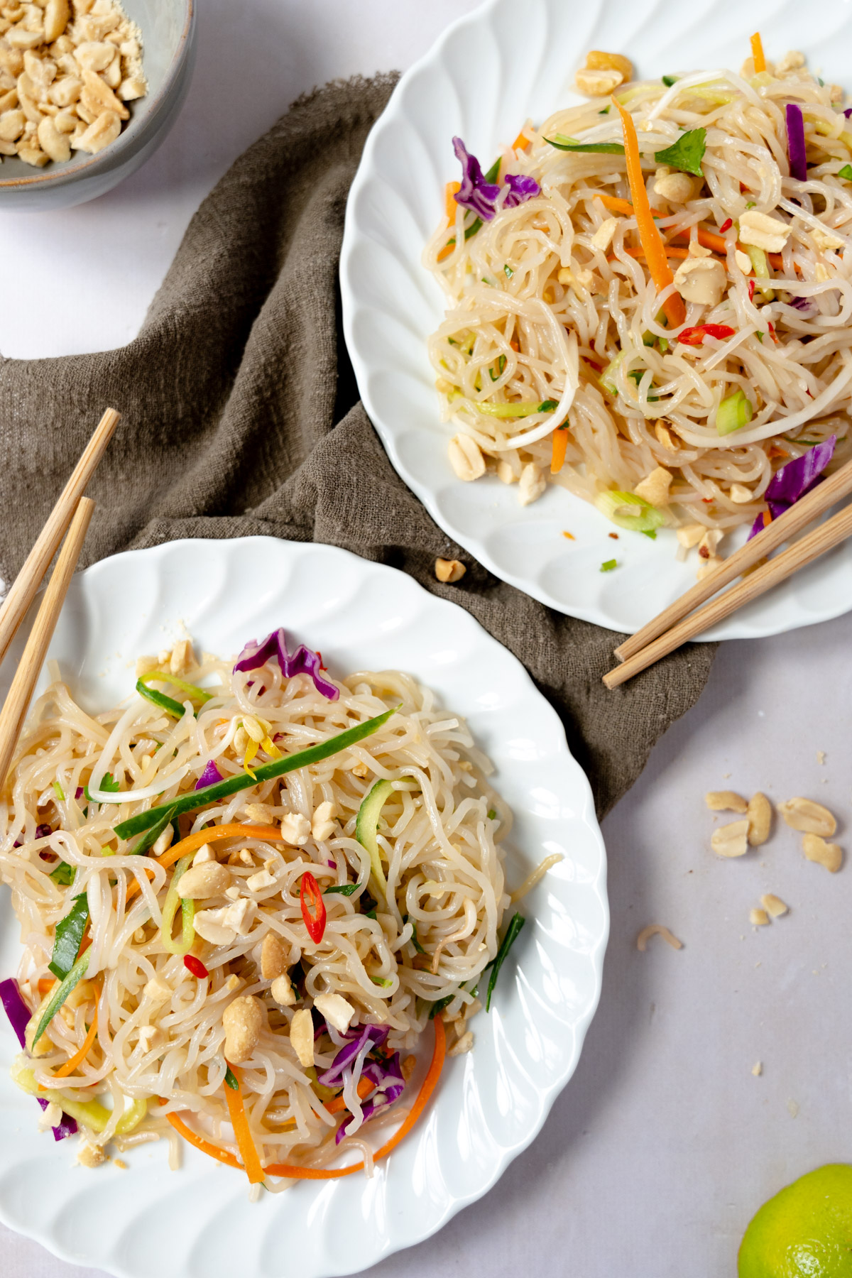 two plates of cold noodle salad with chop sticks