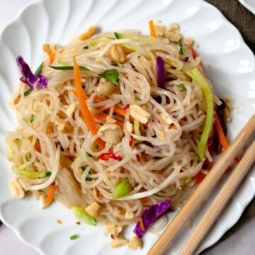 a plate of cold glass noodle salad with chopsticks