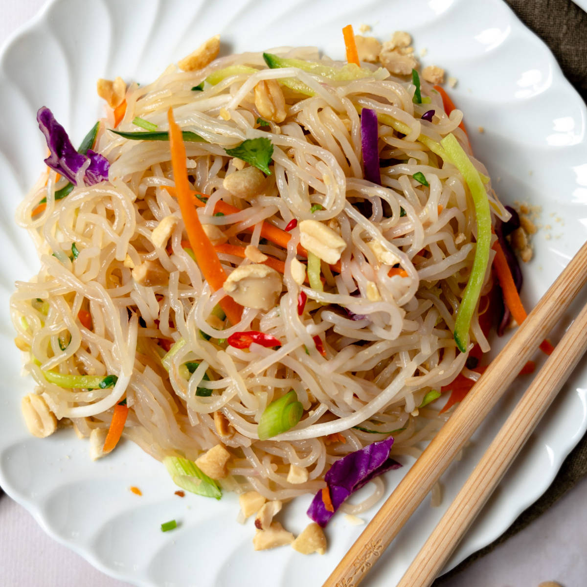 glass noodle salad up close in a white plate