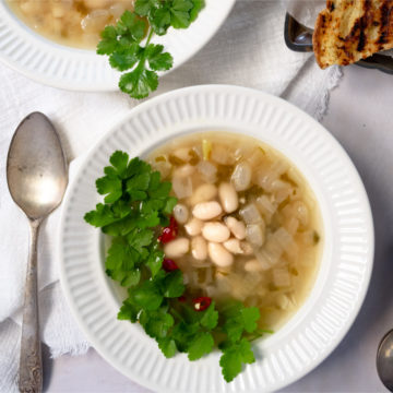 vegan white bean soup in a white bowl