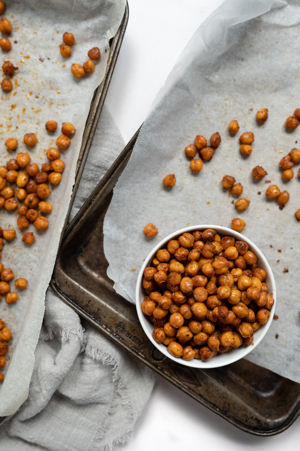 roasted chickpeas in a white bowl on a baking tray