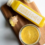 ginger turmeric dressing in a bowl with a trader joe bottle next to it
